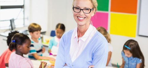 portrait-of-teacher-standing-in-classroom-1536x1024